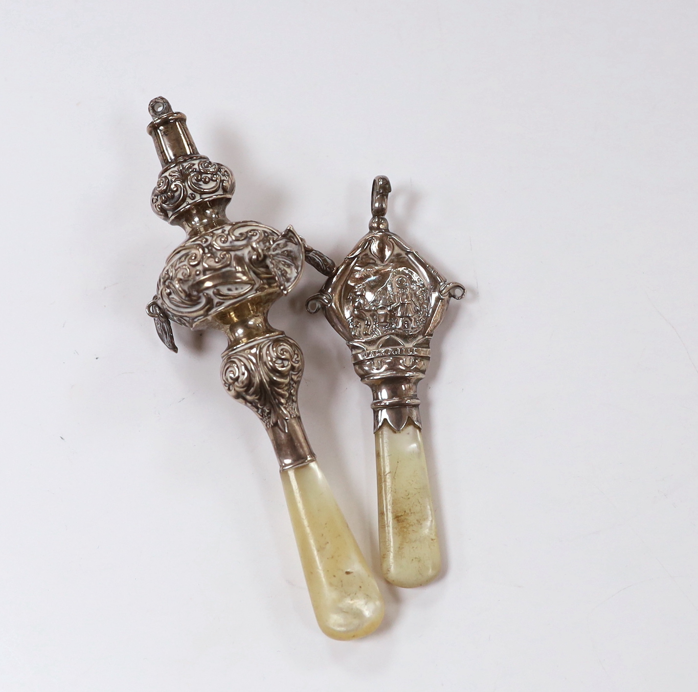 Two George V child's silver rattles, both with mother of pearl teethers, largest 14cm.